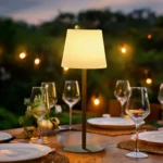 Kreafunk Arc table lamp in green glowing on a table