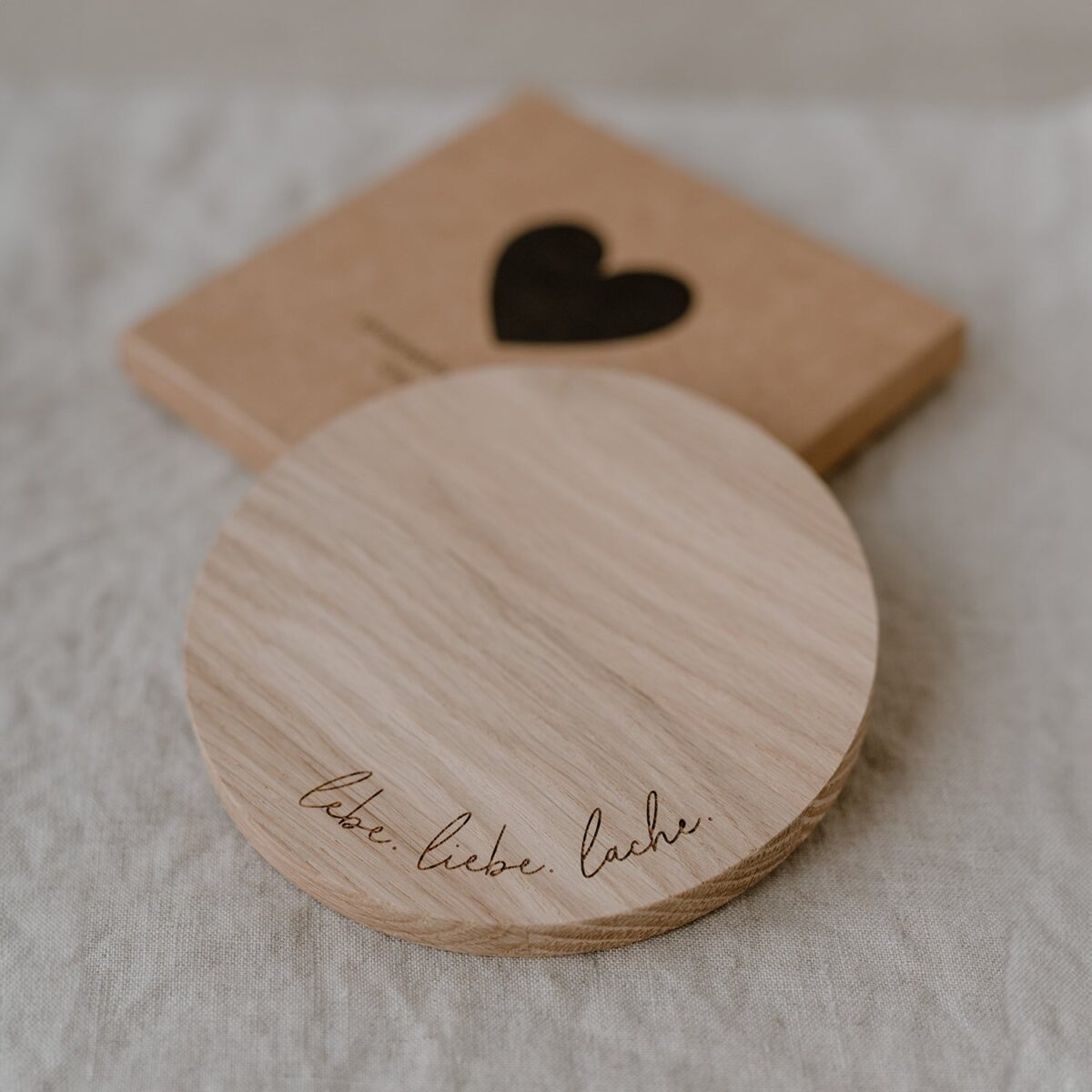 Owl cut coaster made of oak with the saying Lebe. Love. Laugh.