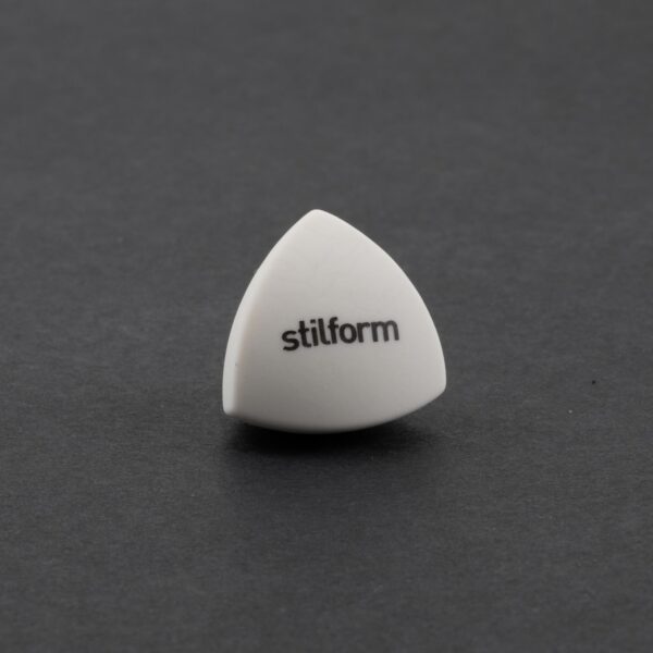 Stilform eraser in the shape of a Reuleaux tetrahedron against a gray background