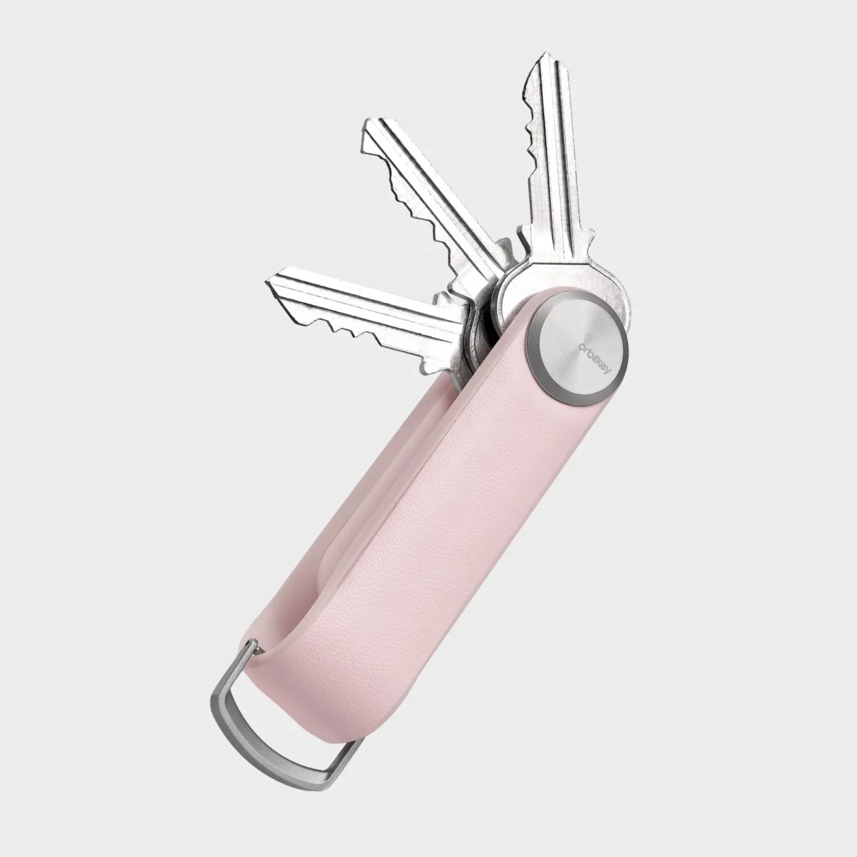 Orbitkey Key Organiser Tracker in Blush, geöffnet mit drei aufgefächerten Schlüsseln und D-Ring
