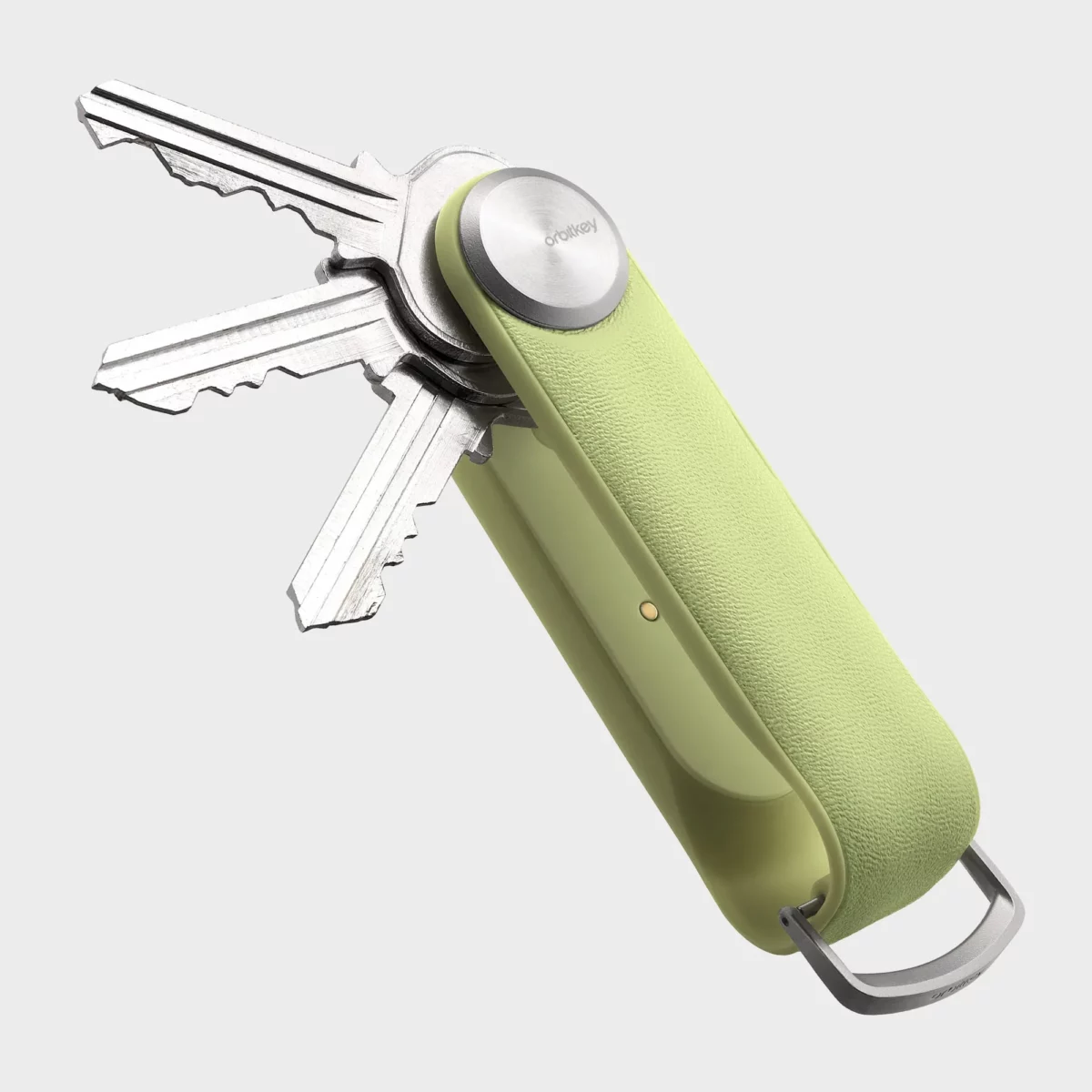 Rückseite des Orbitkey Key Organiser Tracker in Citrus, Schlüssel ausgeklappt, Ladekontakt am Tracker-Modul