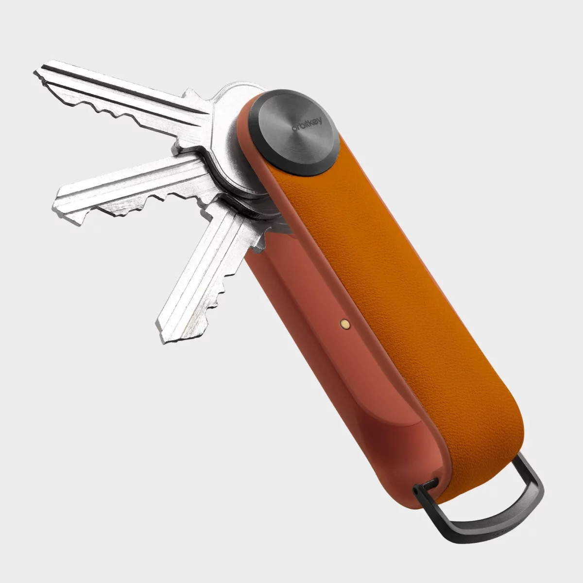 Rückseite des Orbitkey Key Organiser Tracker in Orange, Schlüssel ausgeklappt, Ladekontakt am Tracker-Modul