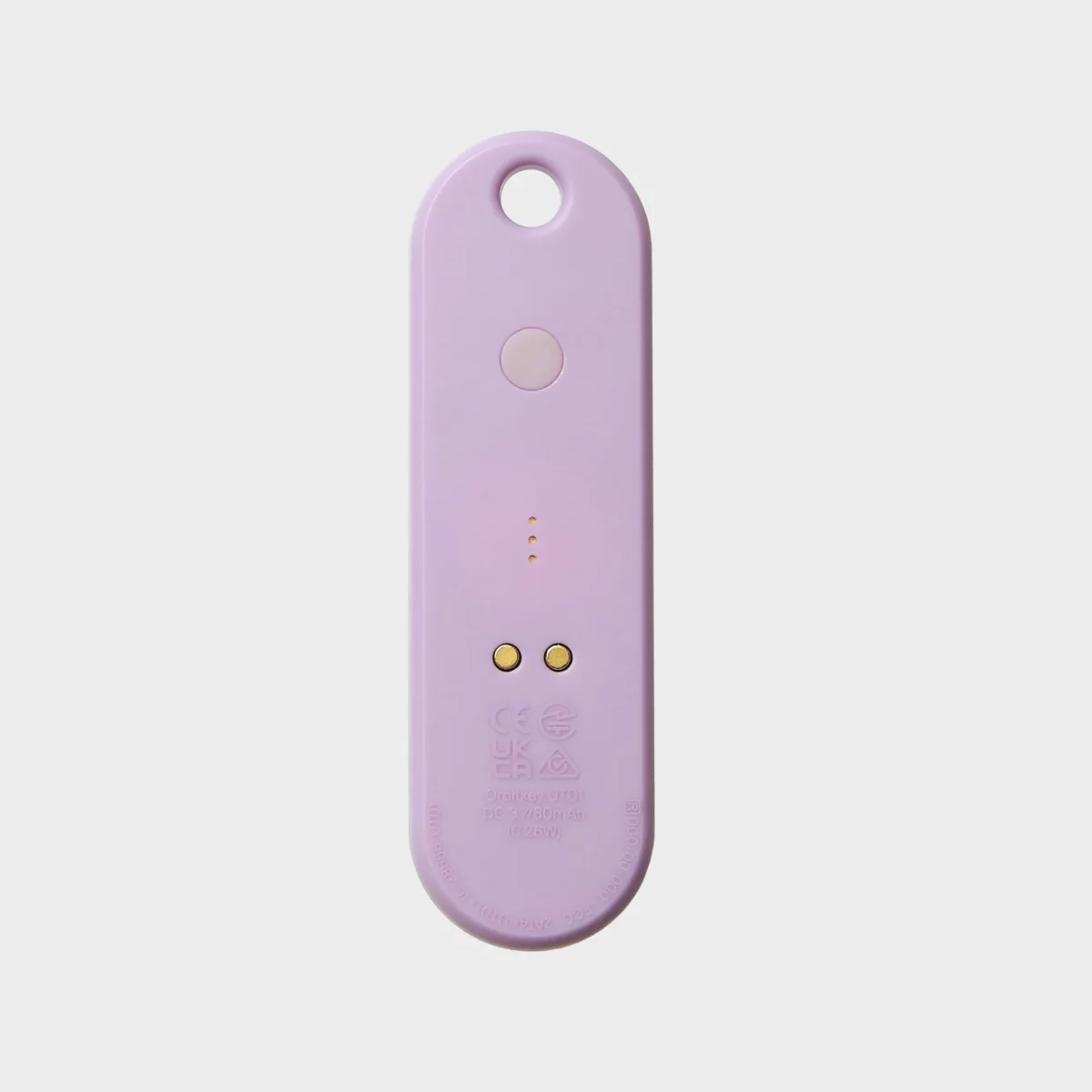 Rückseite des Orbitkey Universal Tracker in Lila mit Taste und zwei magnetischen Ladekontakten