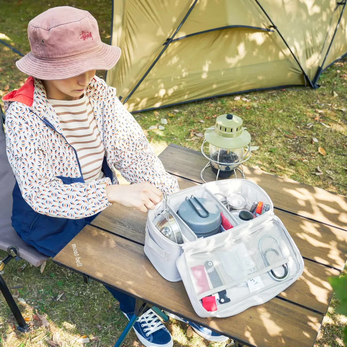 Yamazaki TOWER Storage Bag with Dividers in Gray, laid out on the camping table with dishes and cables