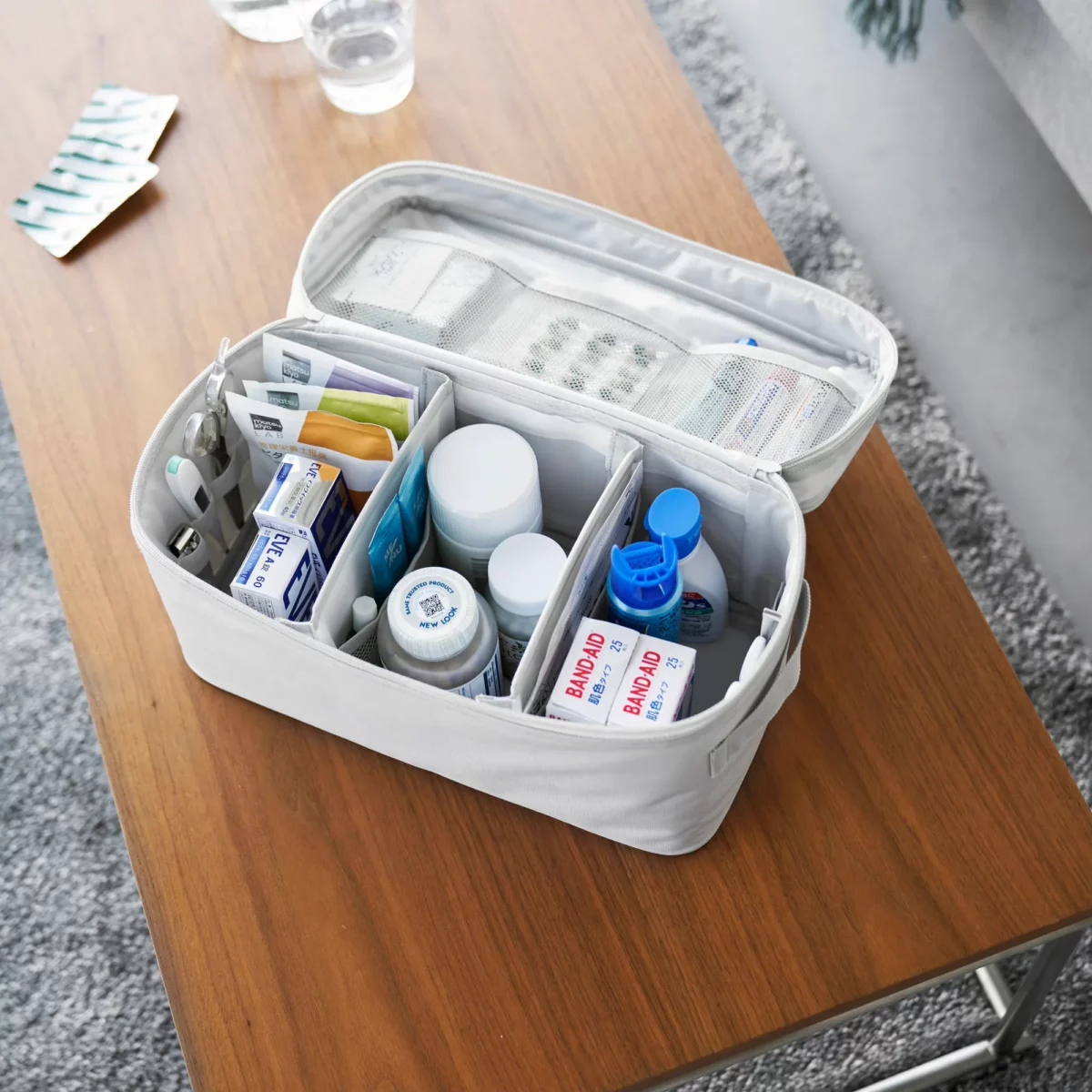 Yamazaki TOWER Storage Bag with Dividers in Gray, shown from above with medications in three compartments
