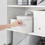 Yamazaki TOWER Storage Bag with Dividers in Gray, pulled out of the cabinet shelf by the side handle