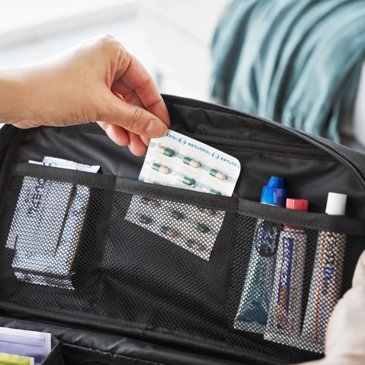 Yamazaki TOWER Storage Pouch with Dividers in Black; the handle allows you to remove pills from the mesh pocket in the lid
