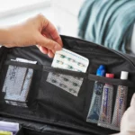 Yamazaki TOWER Storage Pouch with Dividers in Black; the handle allows you to remove pills from the mesh pocket in the lid