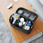 Yamazaki TOWER Storage Bag with Dividers in Black, shown from above with medications in three compartments