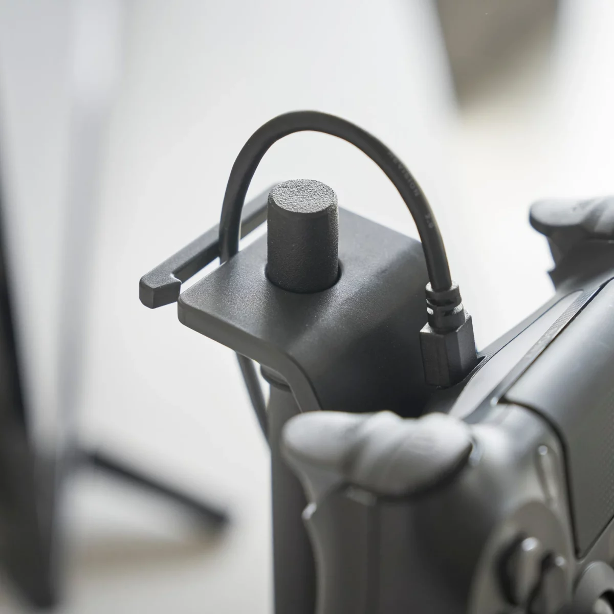 Yamazaki SMART 3-Tier Controller Stand in Black, close-up of the clip that holds the charging cable