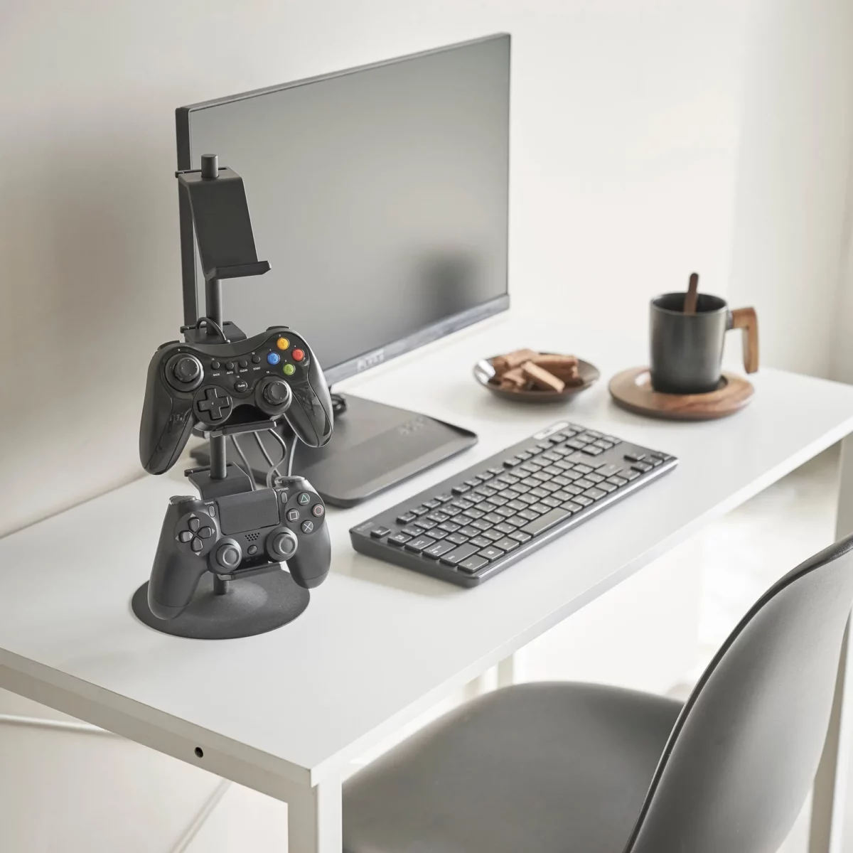 Yamazaki SMART 3-Tier Controller Stand in Black, on the desk next to the monitor and keyboard