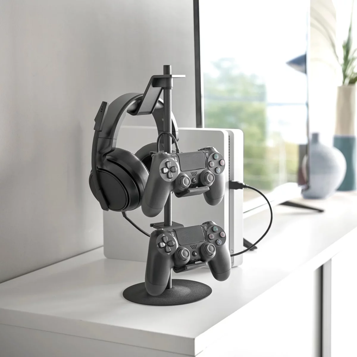 Yamazaki SMART 3-Tier Controller Stand in Black, on the sideboard with a headset and two controllers