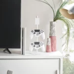 Yamazaki SMART 3-Tier Controller Stand in White, next to the TV with two controllers