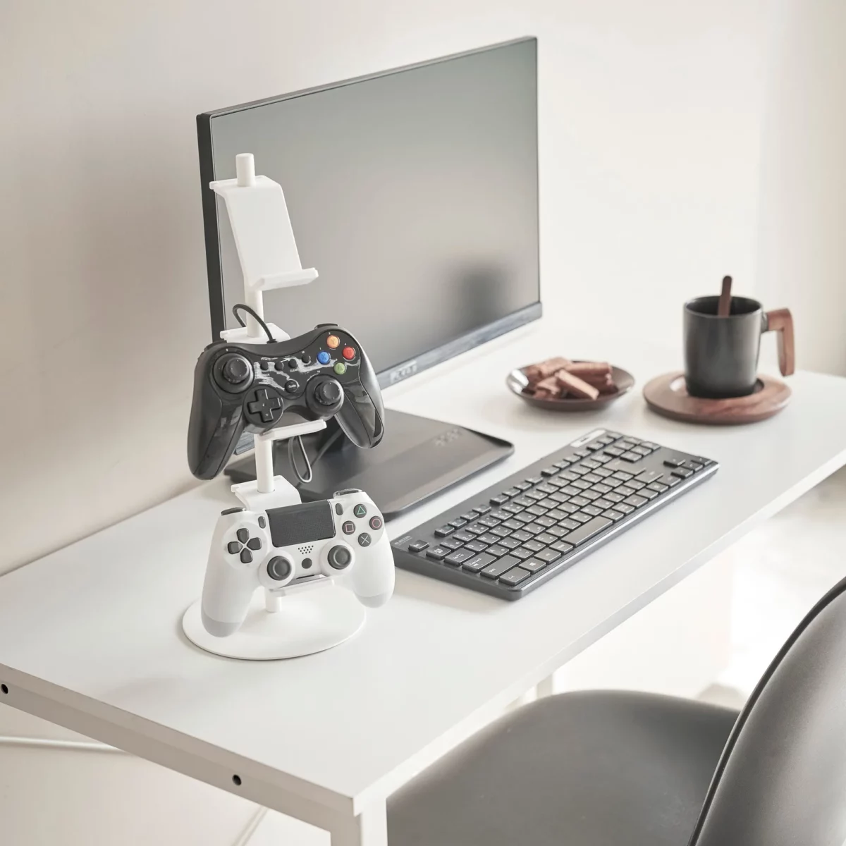 Yamazaki SMART 3-Tier Controller Stand in White, on the desk next to the monitor and keyboard