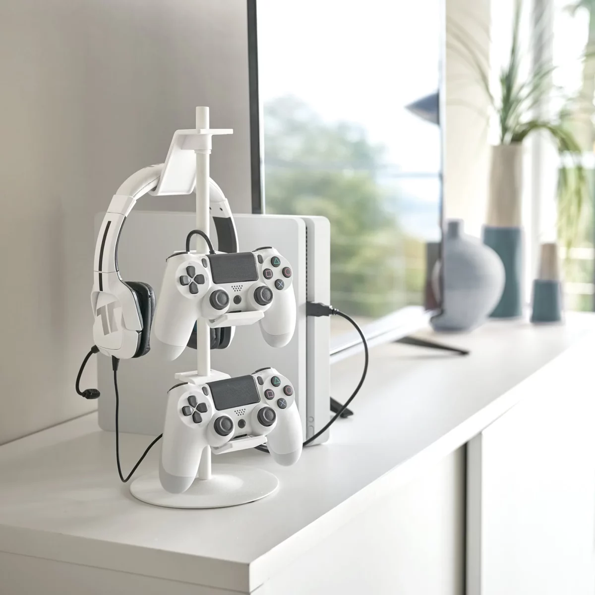 Yamazaki SMART 3-Tier Controller Stand in White, on the sideboard with a headset and two controllers