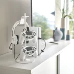 Yamazaki SMART 3-Tier Controller Stand in White, on the sideboard with a headset and two controllers