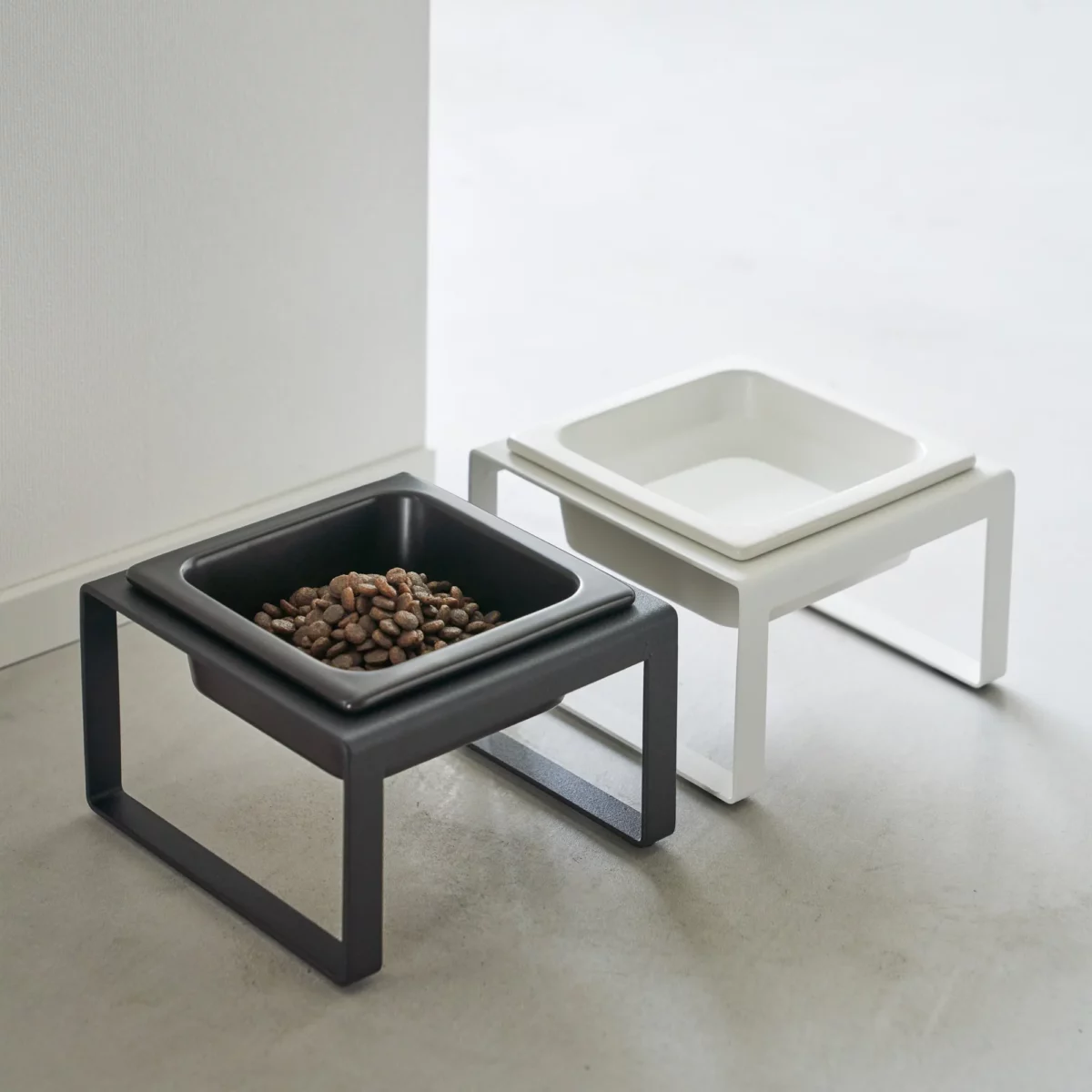 Yamazaki TOWER Food Bowl, single unit with stand; TOWER food bowls in black and white side by side on the floor