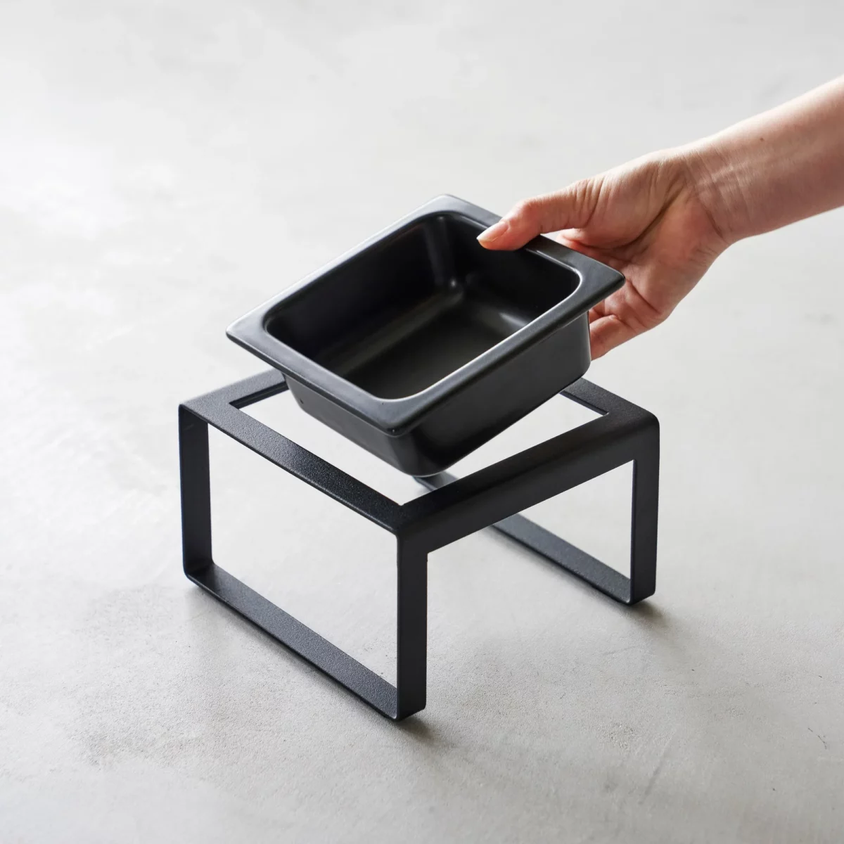Yamazaki TOWER Food Bowl, single, with stand in black; the ceramic bowl lifts out of the stand by hand