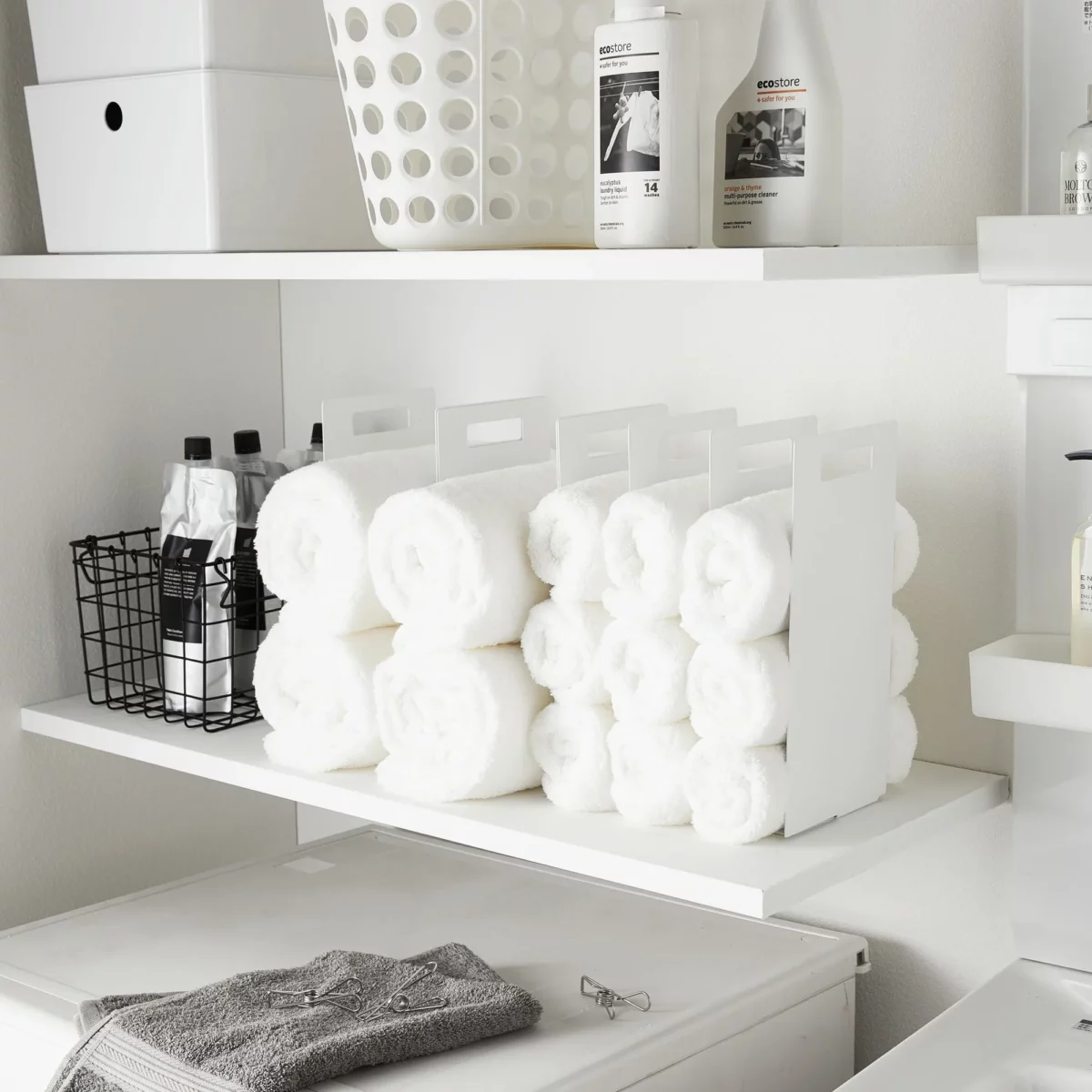 Yamazaki TOWER Towel Storage, 2-Piece Set in White, showing two rows of rolled towels on the shelf from the front