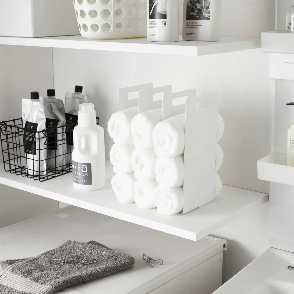 Yamazaki TOWER Towel Storage, Set of 2 in White, with rolled towels on the laundry room shelf