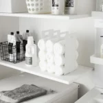 Yamazaki TOWER Towel Storage, Set of 2 in White, with rolled towels on the laundry room shelf