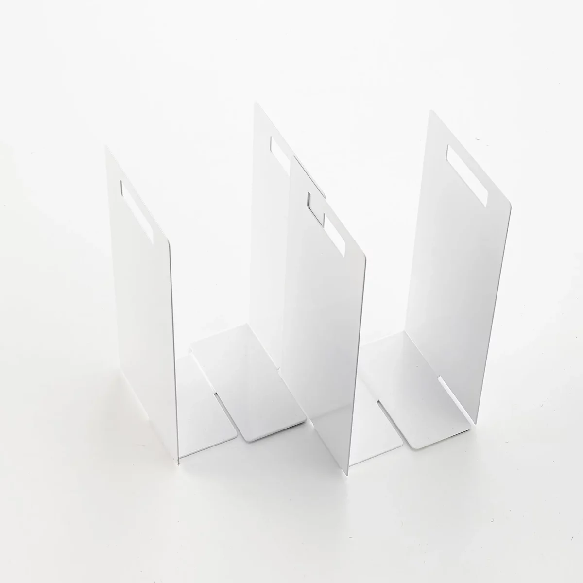 Yamazaki TOWER Towel Storage, 2-Piece Set in White; the two pieces are arranged in a staggered configuration to accommodate different shelf widths