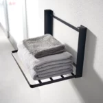 Yamazaki TOWER Folding Wall Shelf in Black, close-up with towels on the steel struts