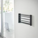 Yamazaki TOWER Folding Wall Shelf in Black; when folded, it lies flat against the bathroom wall