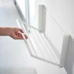 Yamazaki TOWER Folding Wall Shelf in White; the shelf folds down from the wall by hand