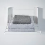 Yamazaki TOWER Folding Wall Shelf in White, with three folded towels in the foreground
