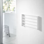 Yamazaki TOWER Folding Wall Shelf in White; when folded, it lies flat against the bathroom wall