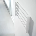 Yamazaki TOWER Folding Wall Shelf in White, shown folded and mounted on the wall (side view)