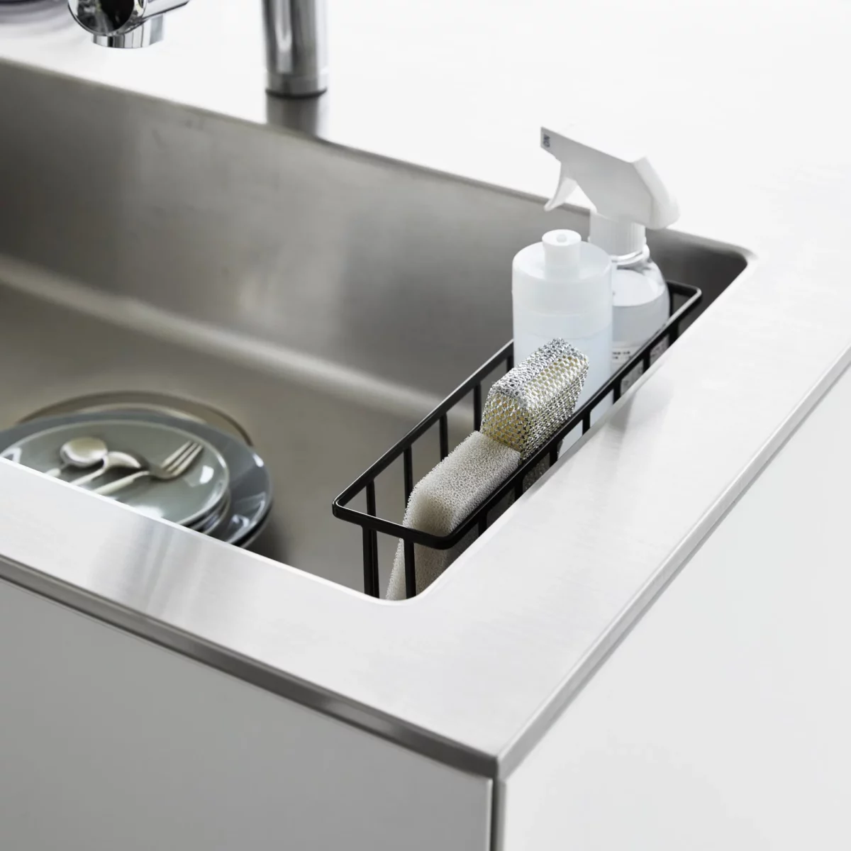 Yamazaki TOWER Film Hook multi-use basket L in black, top view inside the sink with bottles and a sponge
