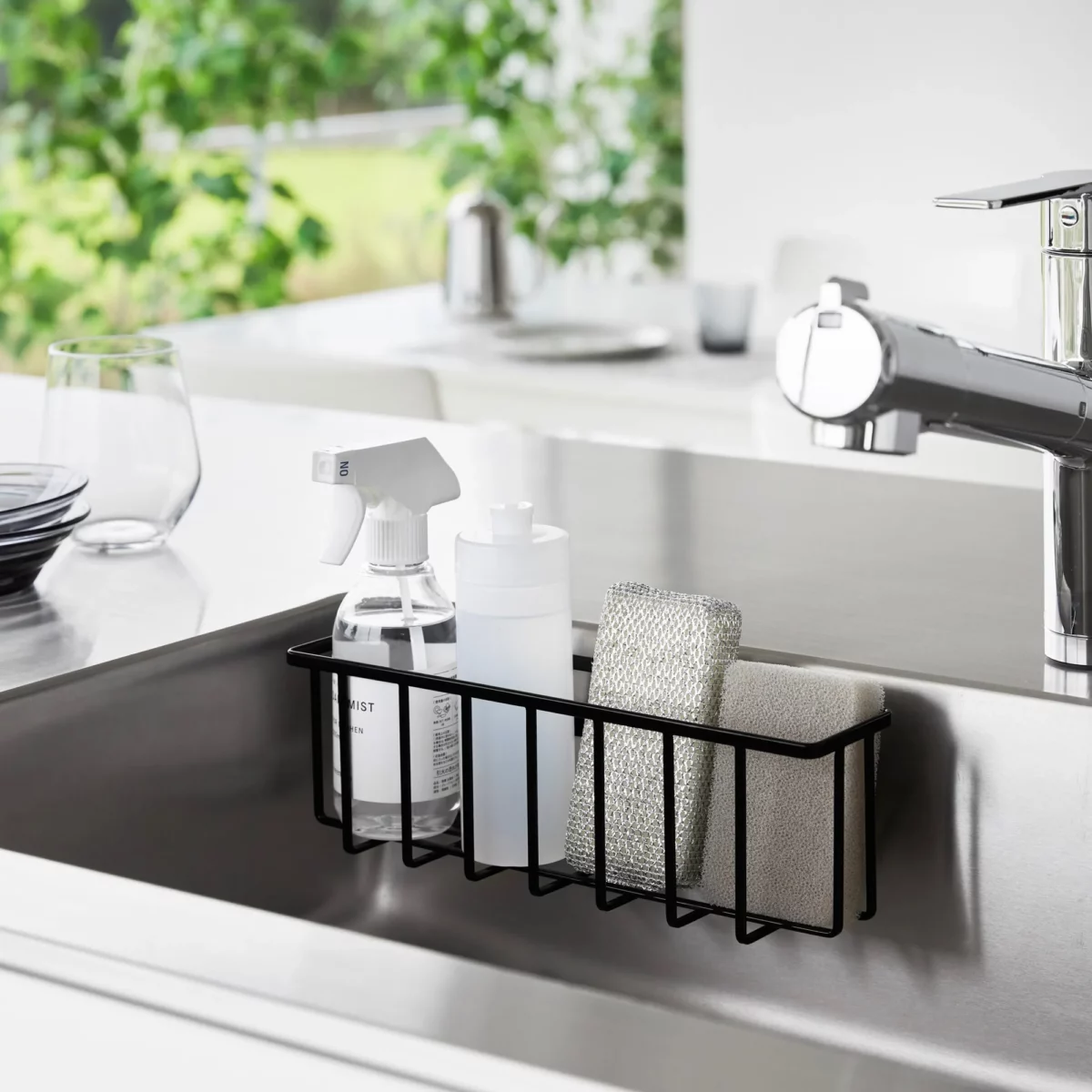 Yamazaki TOWER Film Hook multi-use basket L in black, inside the sink wall with dish soap and a sponge