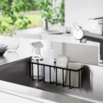 Yamazaki TOWER Film Hook multi-use basket L in black, inside the sink wall with dish soap and a sponge