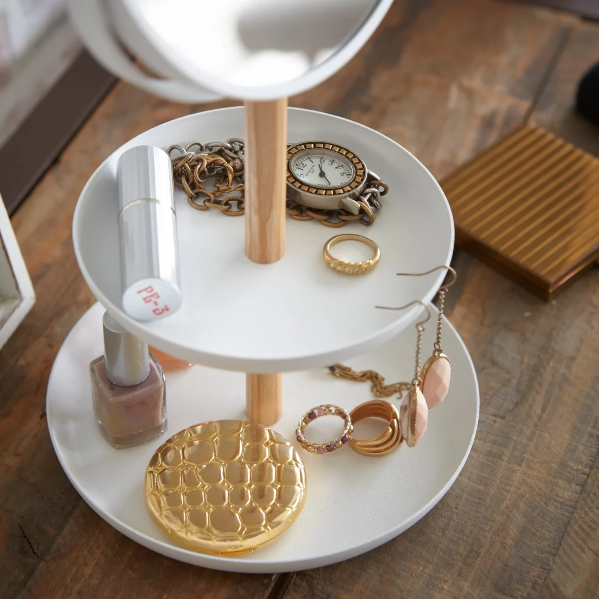 Yamazaki TOSCA Makeup Mirror with Shelves in White; Close-up of the Shelves Featuring a Clock, Rings, Lipstick, and Powder Compact