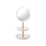 Yamazaki TOSCA Cosmetic Mirror with Shelves in White, shown empty with a round mirror and wooden rod