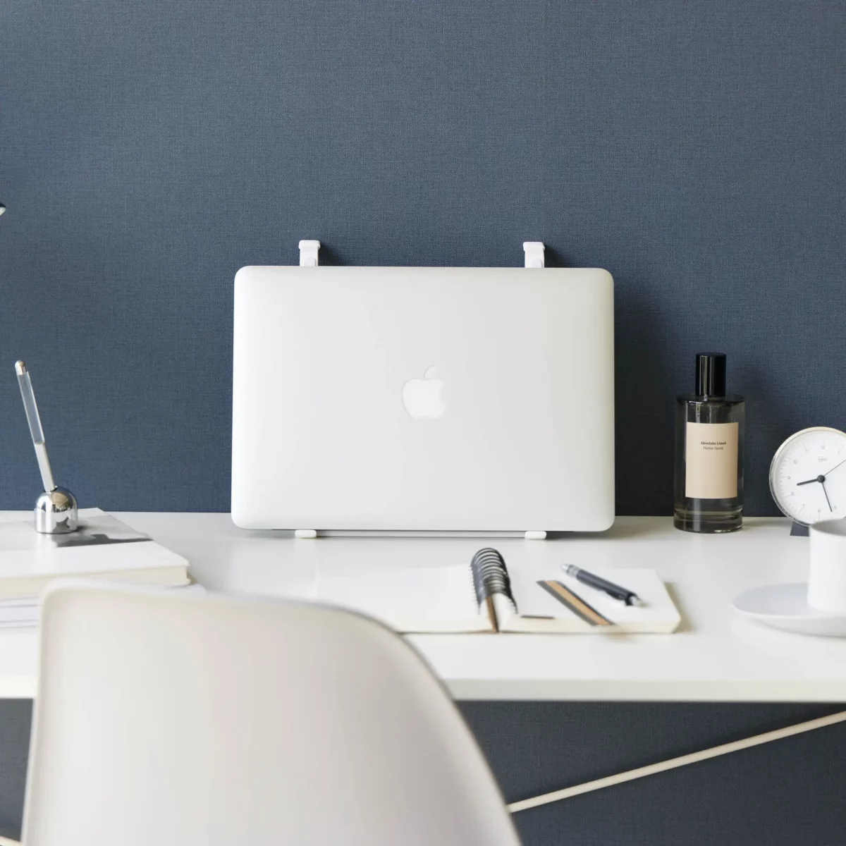 Support 2 en 1 TOWER pour ordinateur et tablette Yamazaki coloris blanc, debout de face avec ordinateur devant un mur bleu