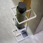 Yamazaki TOWER Slim Umbrella Stand in White, shown from above with a folding umbrella in the top compartment