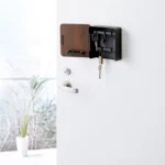 Yamazaki RIN Magnetic Key Box in Black, placed open next to the door handle on the front door