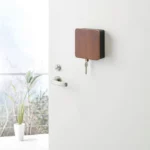 Yamazaki RIN Magnetic Key Box in Black, locked on the front door, with one key hanging from the bottom