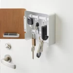 Yamazaki RIN Magnetic Key Box in White, open, showing a car key and key rings in close-up