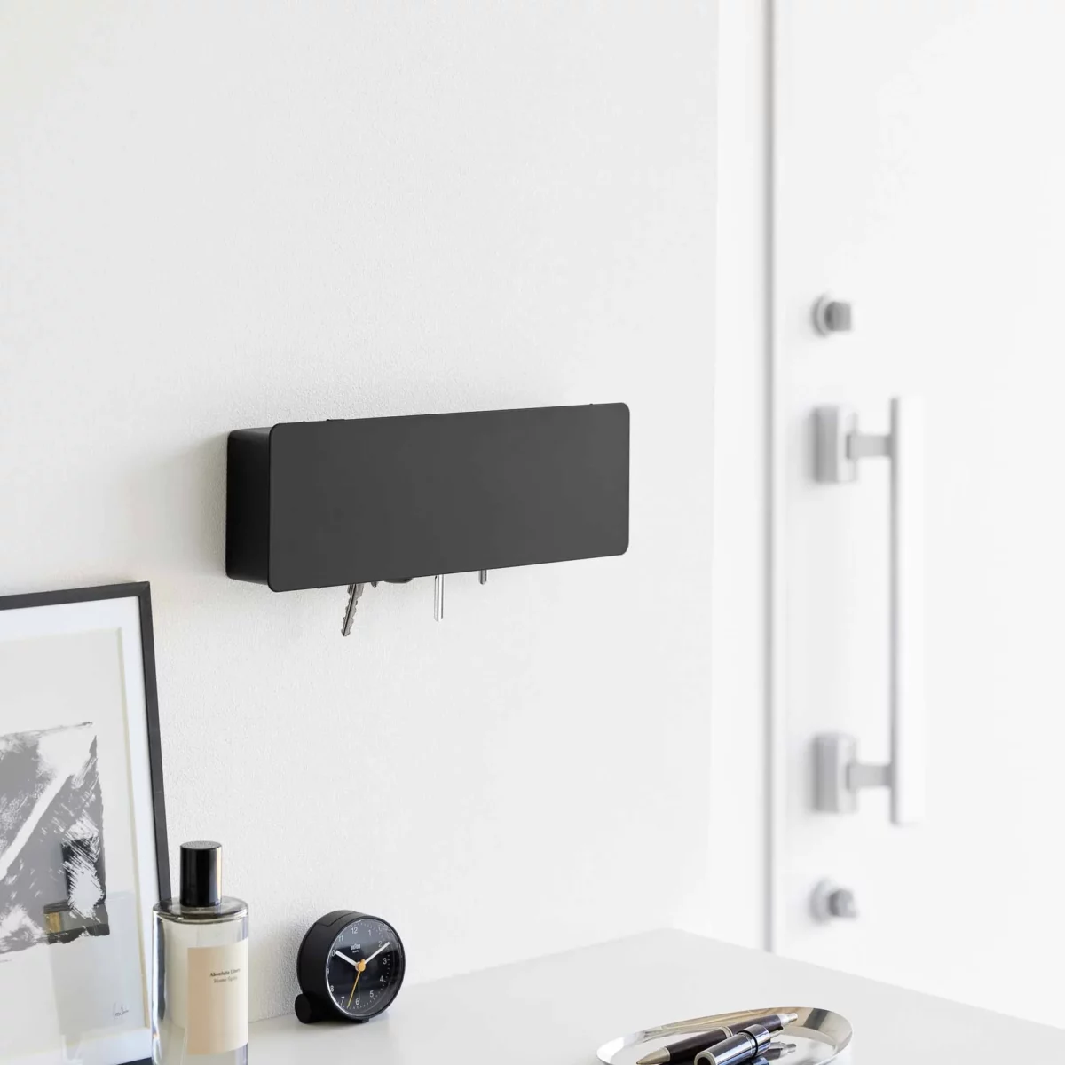 Yamazaki TOWER Wide Key Cabinet in Black, mounted on the wall in the entryway next to the closet