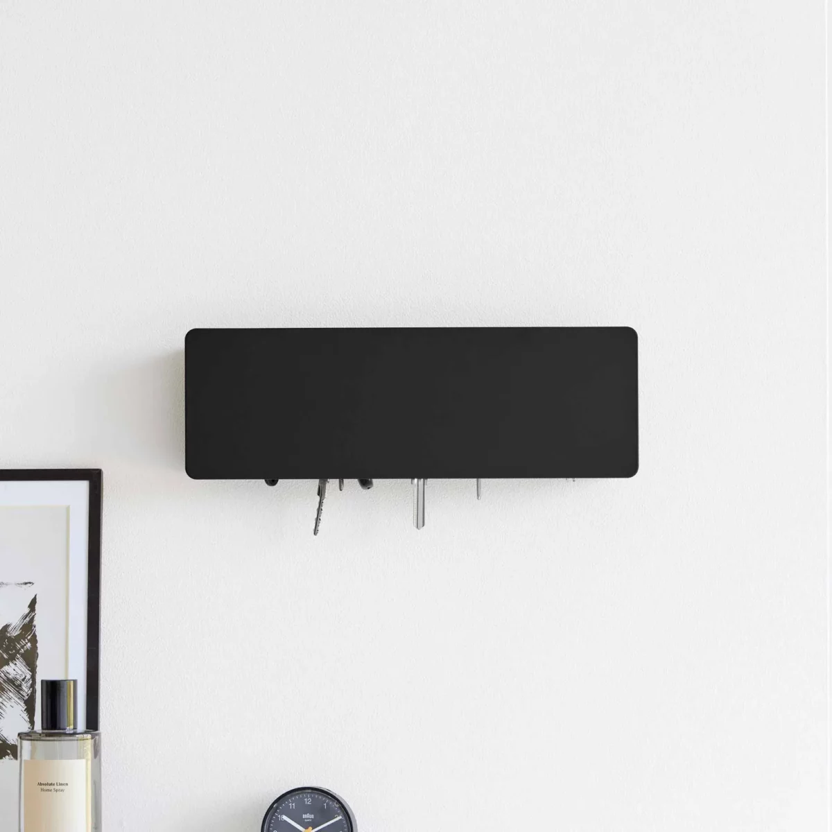 Yamazaki TOWER Wide Key Cabinet in Black, placed on top of a dresser, with the keys visible at the bottom