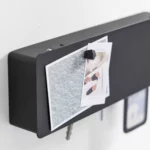 Yamazaki TOWER Wide Key Box in Black, with a postcard and magnet on the lid; keys protrude from the bottom