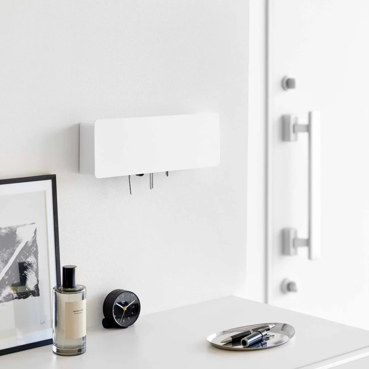 Yamazaki TOWER Wide Key Cabinet in White, mounted on the wall in the entryway next to the closet