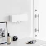 Yamazaki TOWER Wide Key Cabinet in White, mounted on the wall in the entryway next to the closet