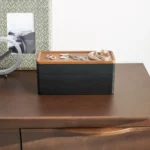 Yamazaki RIN 3-Tier Narrow Jewelry Box in Black, on the dresser in front of a picture frame