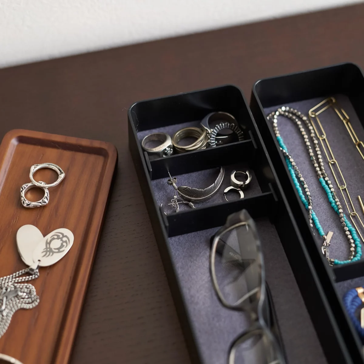 Yamazaki RIN 3-Tier Slim Jewelry Box in Black, close-up of the compartments with rings and earrings