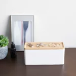 Yamazaki RIN 3-Tier Narrow Jewelry Box in White, on the dresser in front of a picture frame